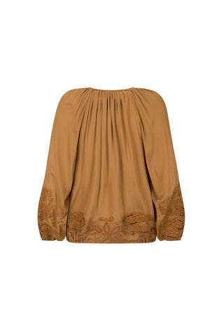 A camel brown long-sleeve blouse with a gathered, pleated neckline and matching embroidered detailing along the lower sleeves and hem, shown against a plain white background.