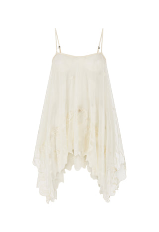 An off-white, semi-sheer spaghetti strap dress with a tiered, ruffled asymmetrical hem and delicate floral embroidery, shown against a plain white background.